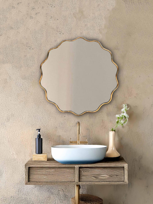 Wavy round mirror above sink