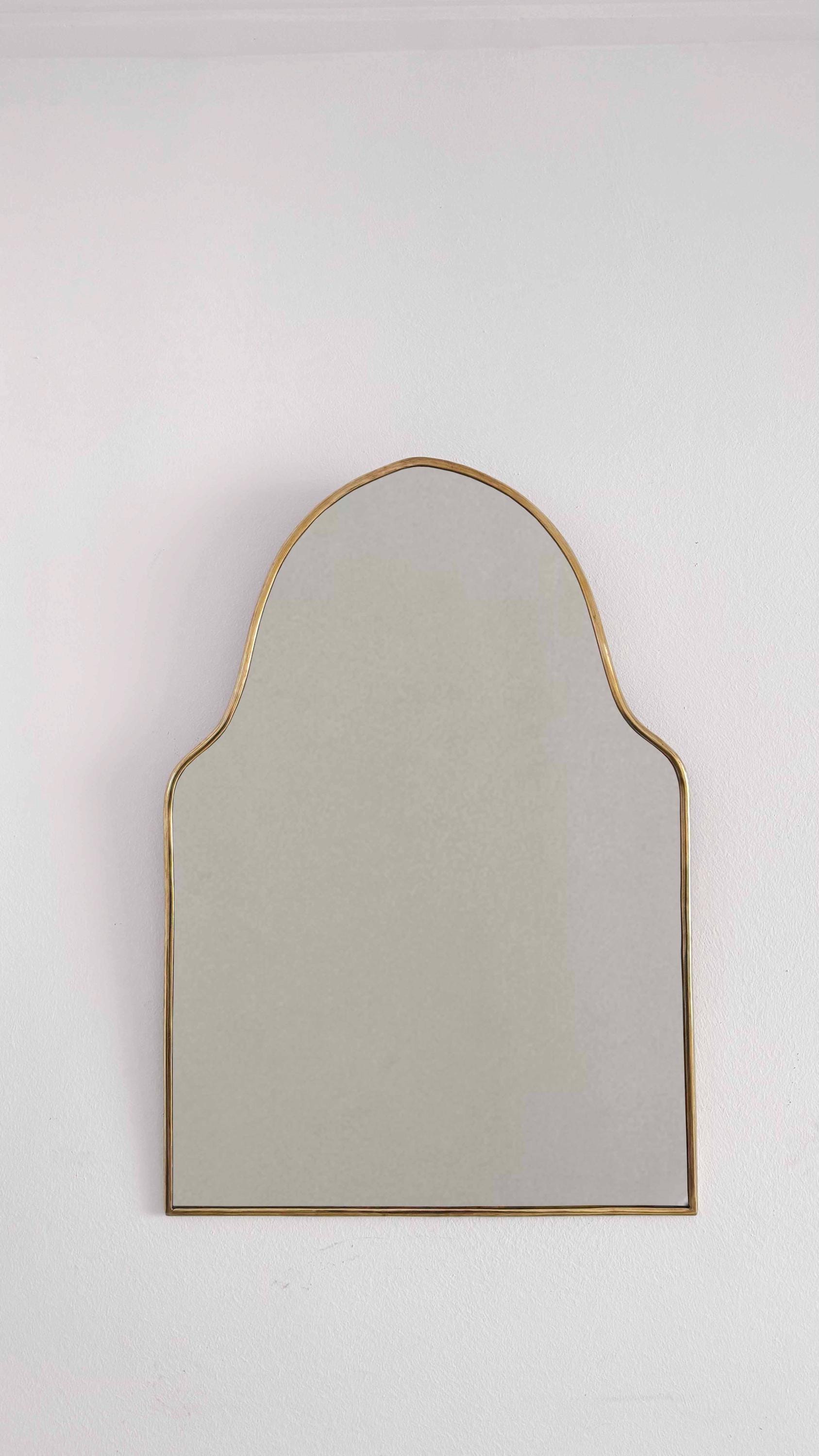 arch brass mirror in white background
