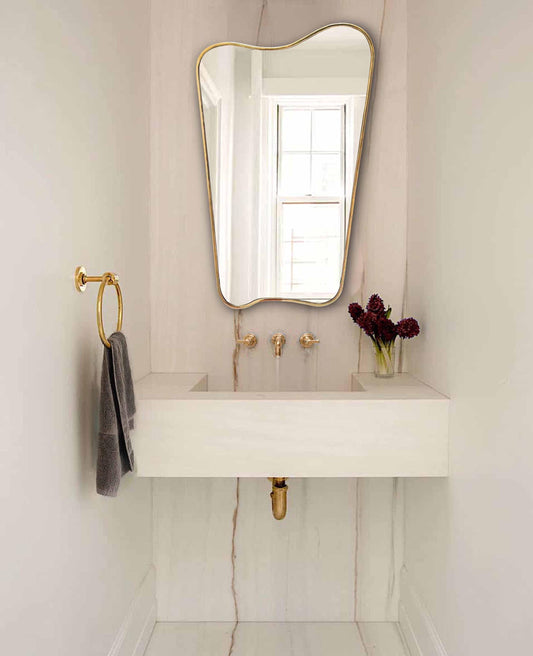 gold brass mirror in powder room