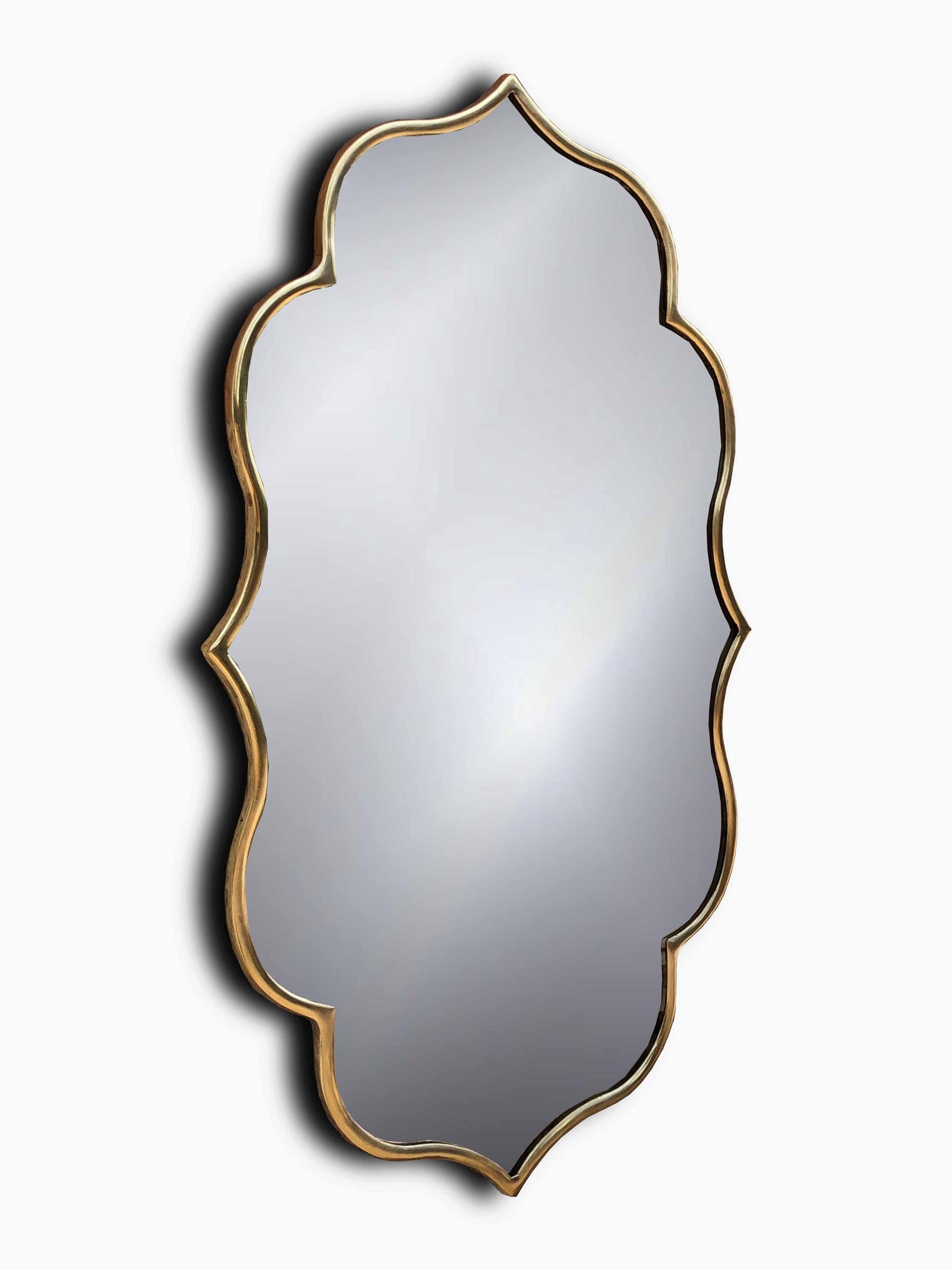 Asymmetrical mirror with gold frame.