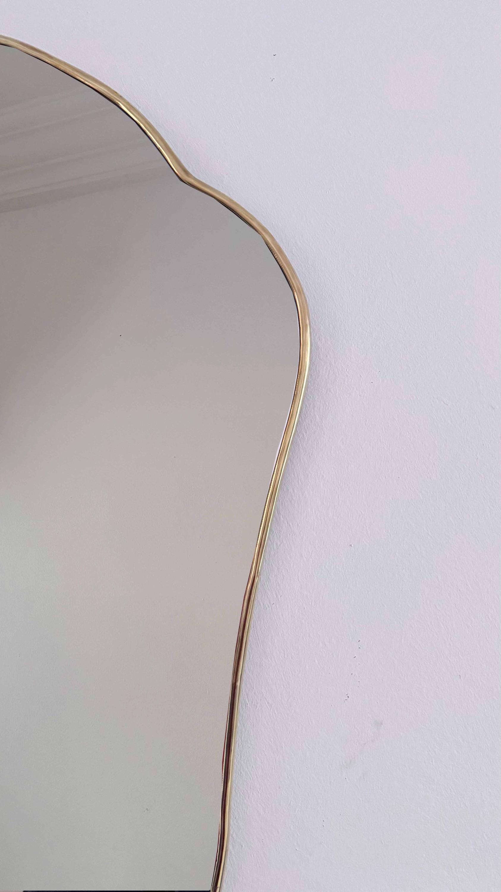 antique brass frame mirror on white wall