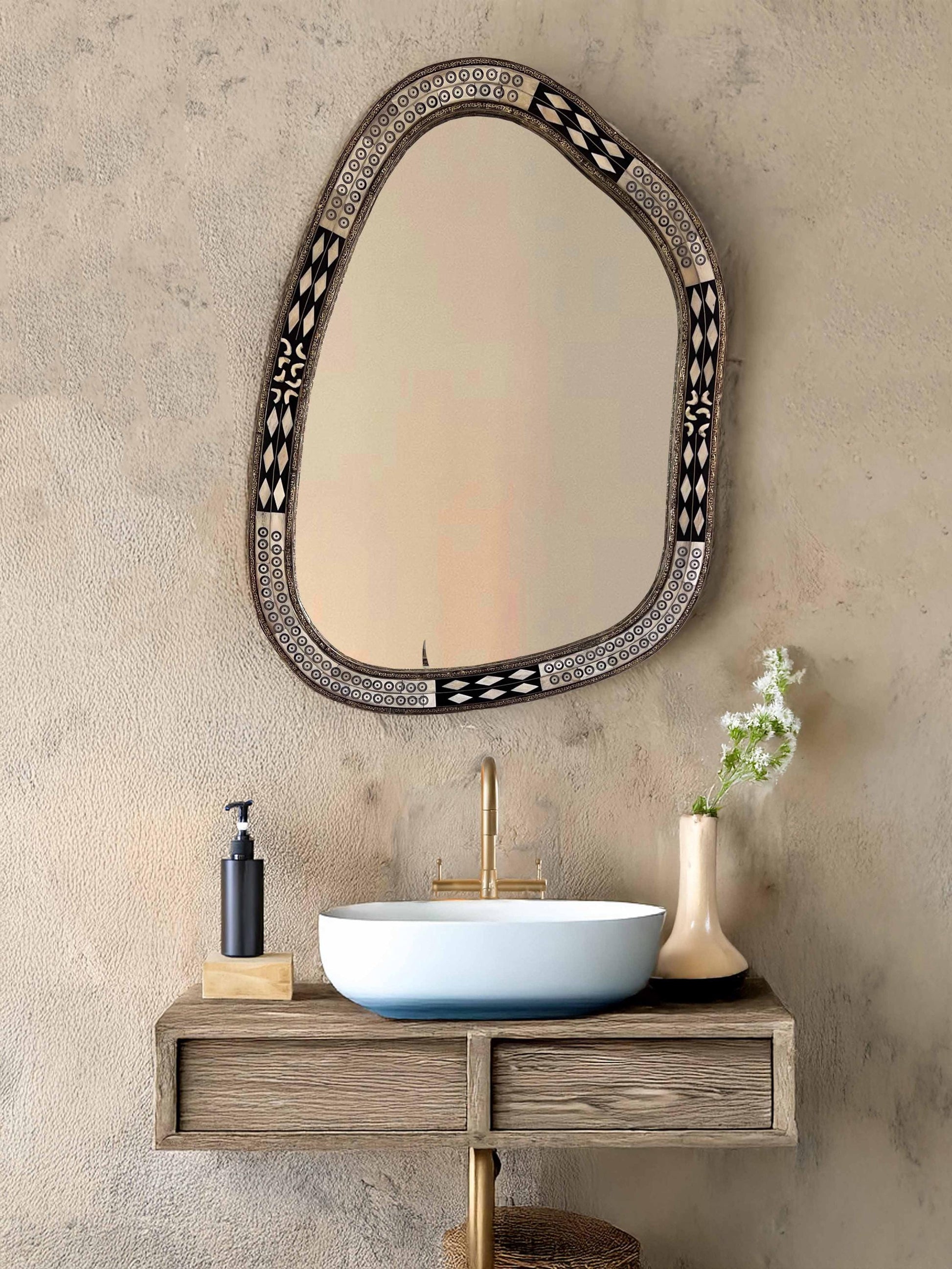 Asymmetrical Mirror in bathroom with brass faucet