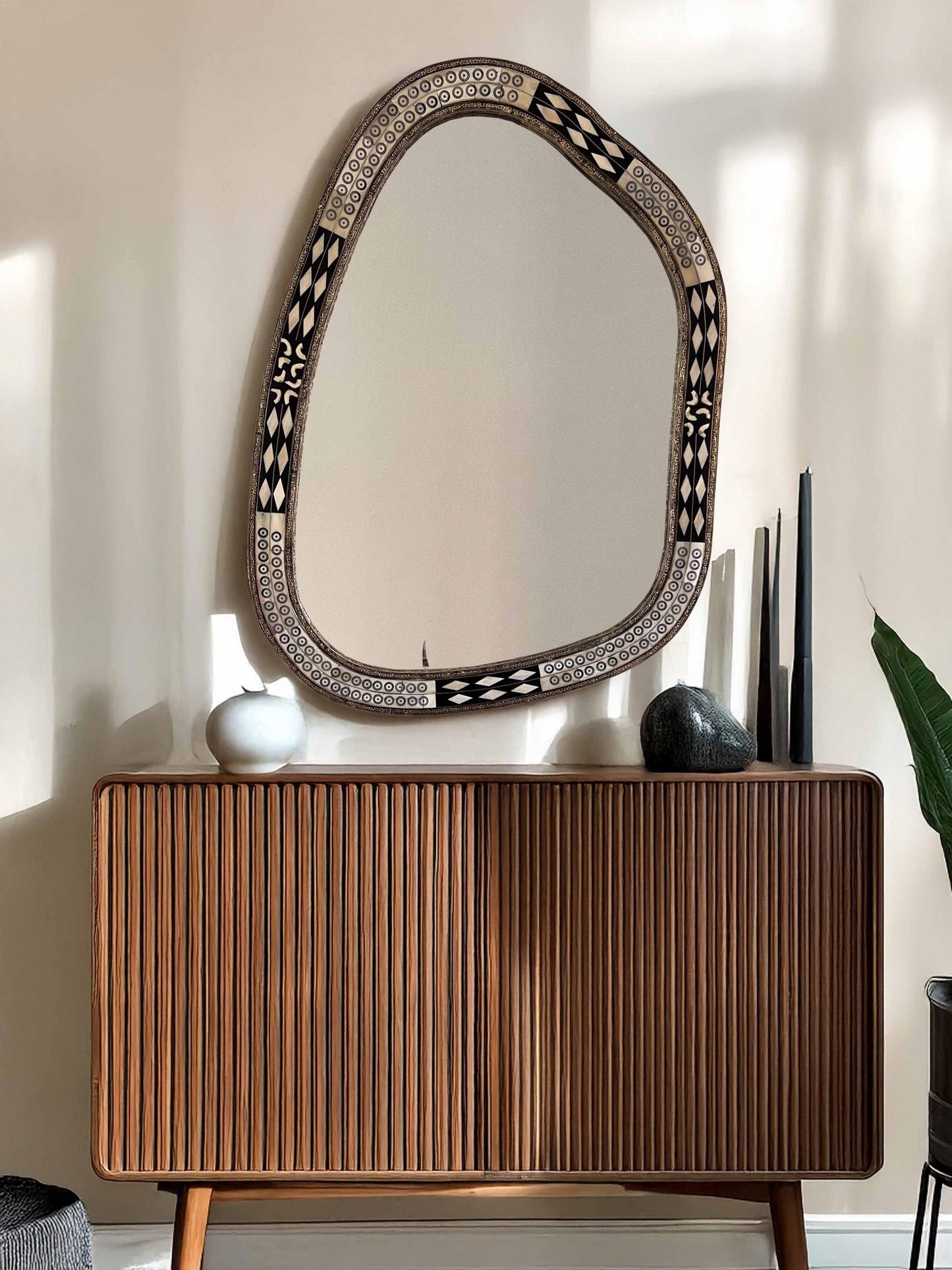 Asymmetrical Mirror above living room brown dresser