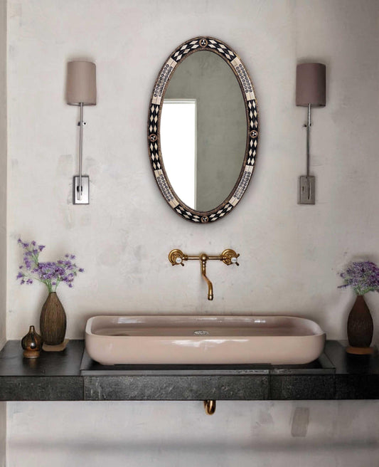 oval bathroom mirror in a cozy powder room