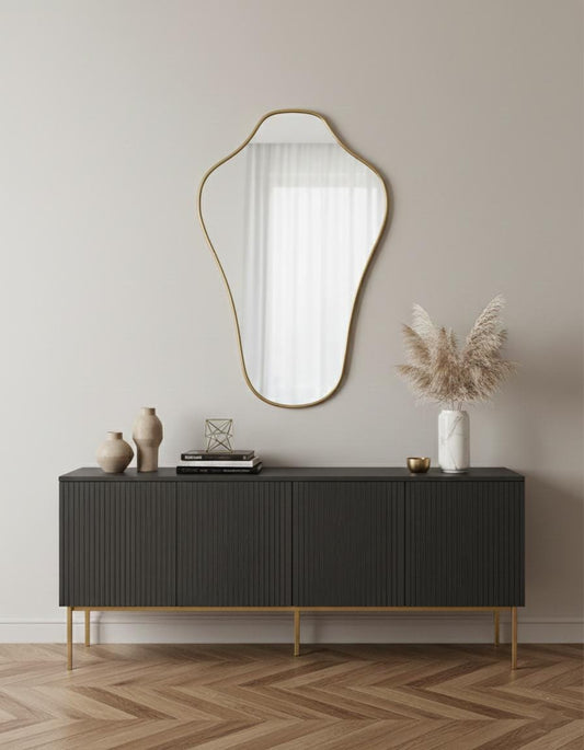 Modern irregular brass wall mirror styled above console