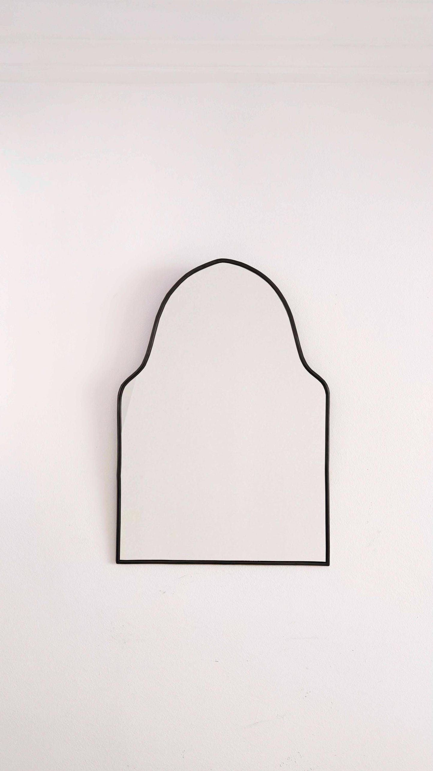 black arch brass mirror in white background