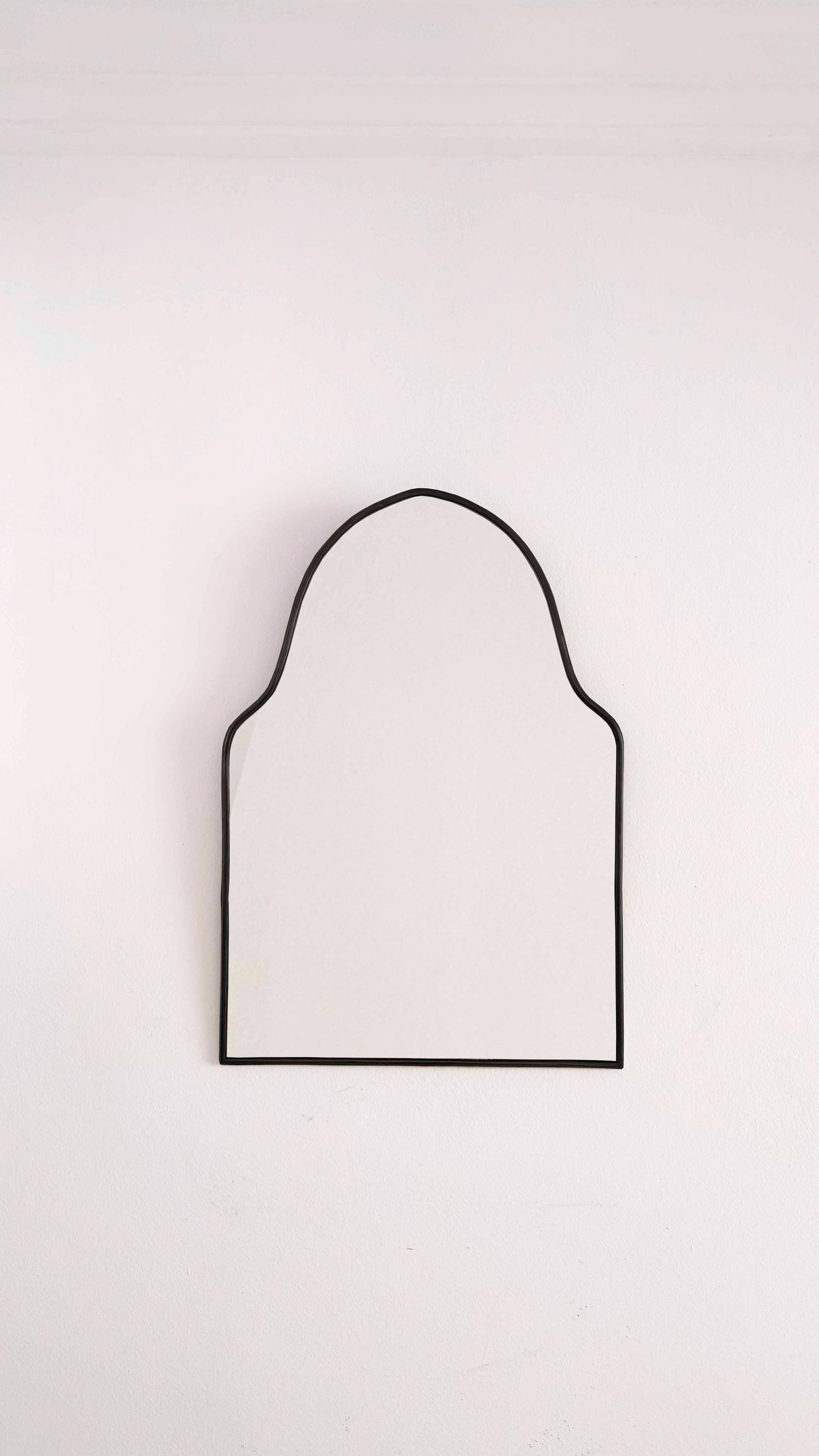 black arch brass mirror in white background