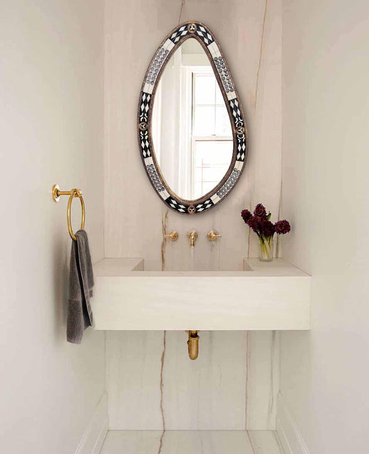 bone and brass bathroom mirror in powder room
