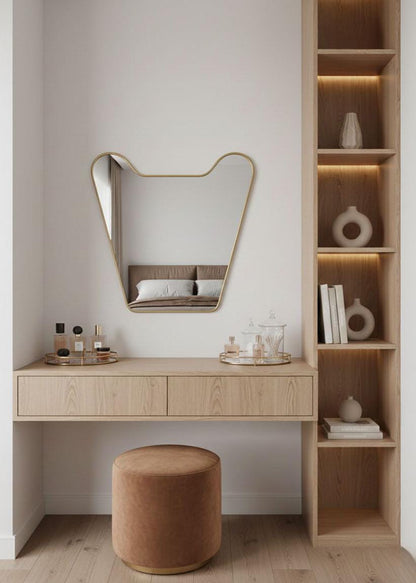 Handmade irregular brass mirror above bedroom console