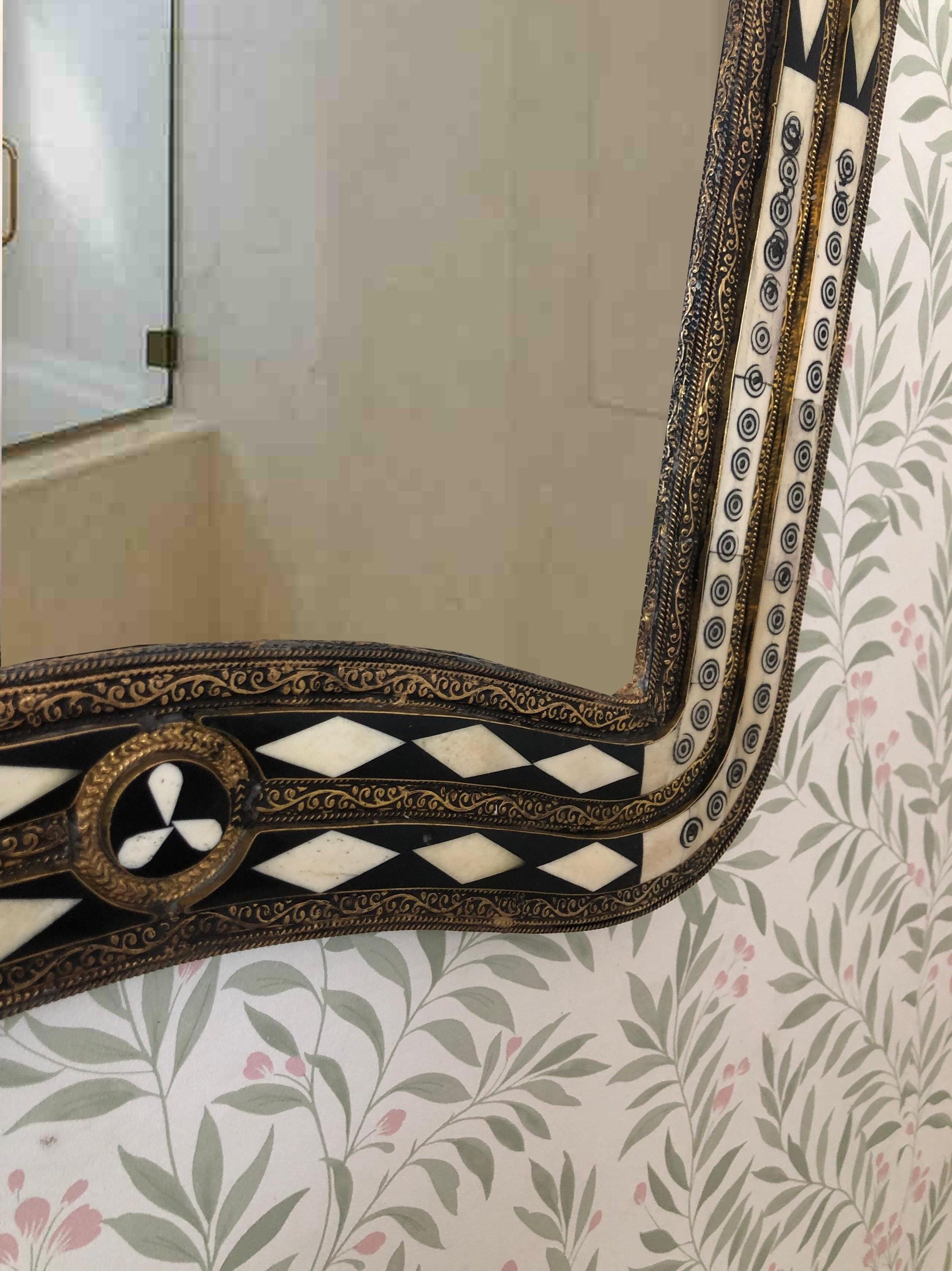 Corner detail of ornate bone inlay mirror.