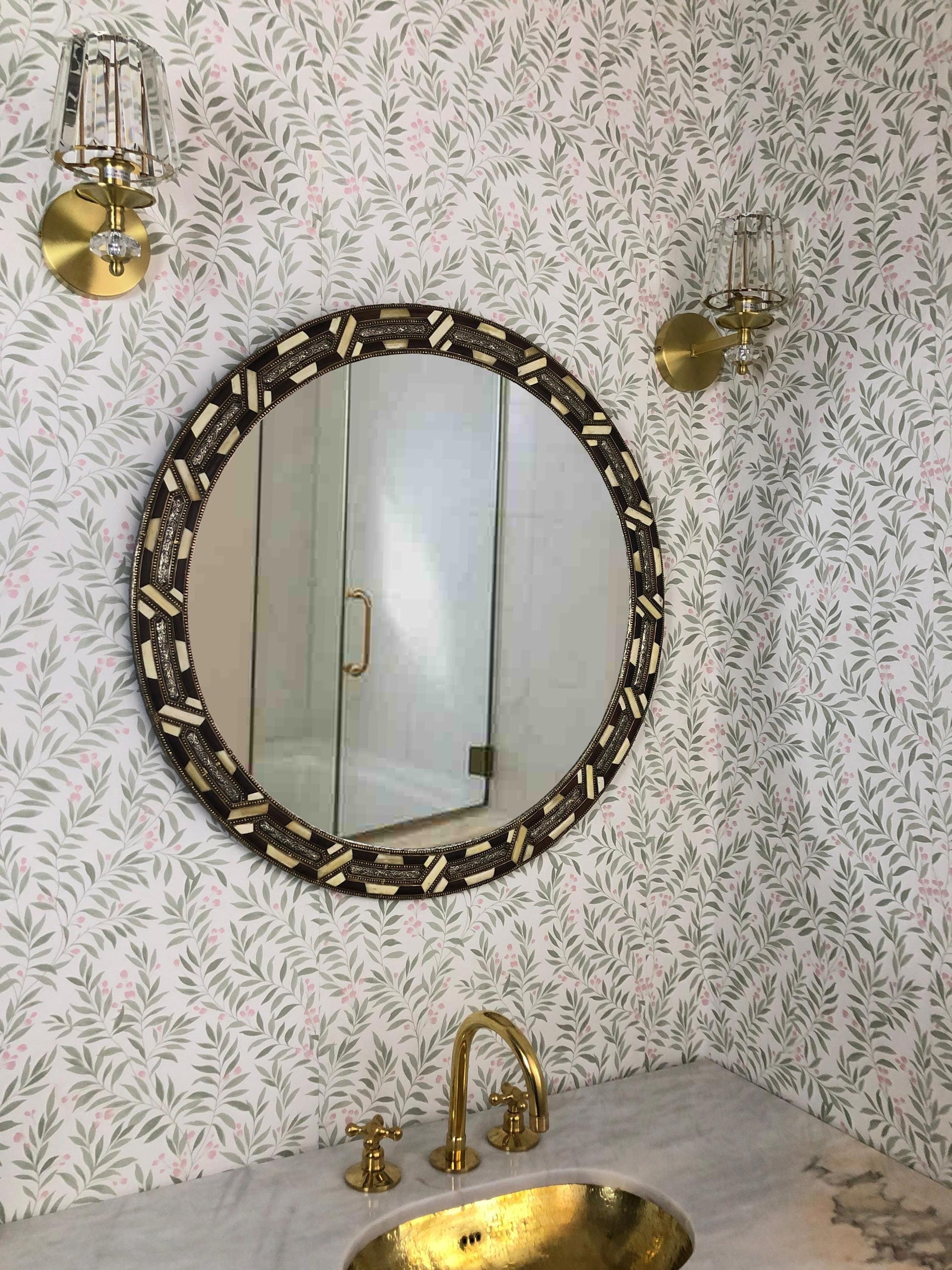Bone inlay mirror above brass faucet