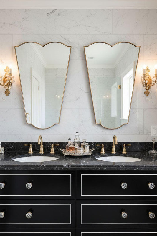 Pair of asymmetrical brass mirrors in double sink bathroom