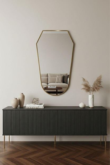 shield brass mirror above modern console