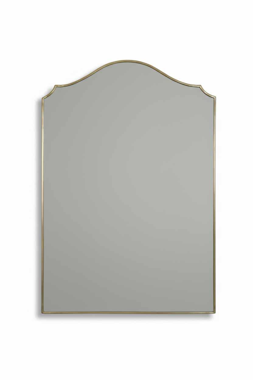 Brass framed arched wall mirror on white background with soft gray reflective surface for product display