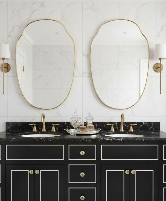 Pair of irregular oval brass mirrors over double bathroom vanity
