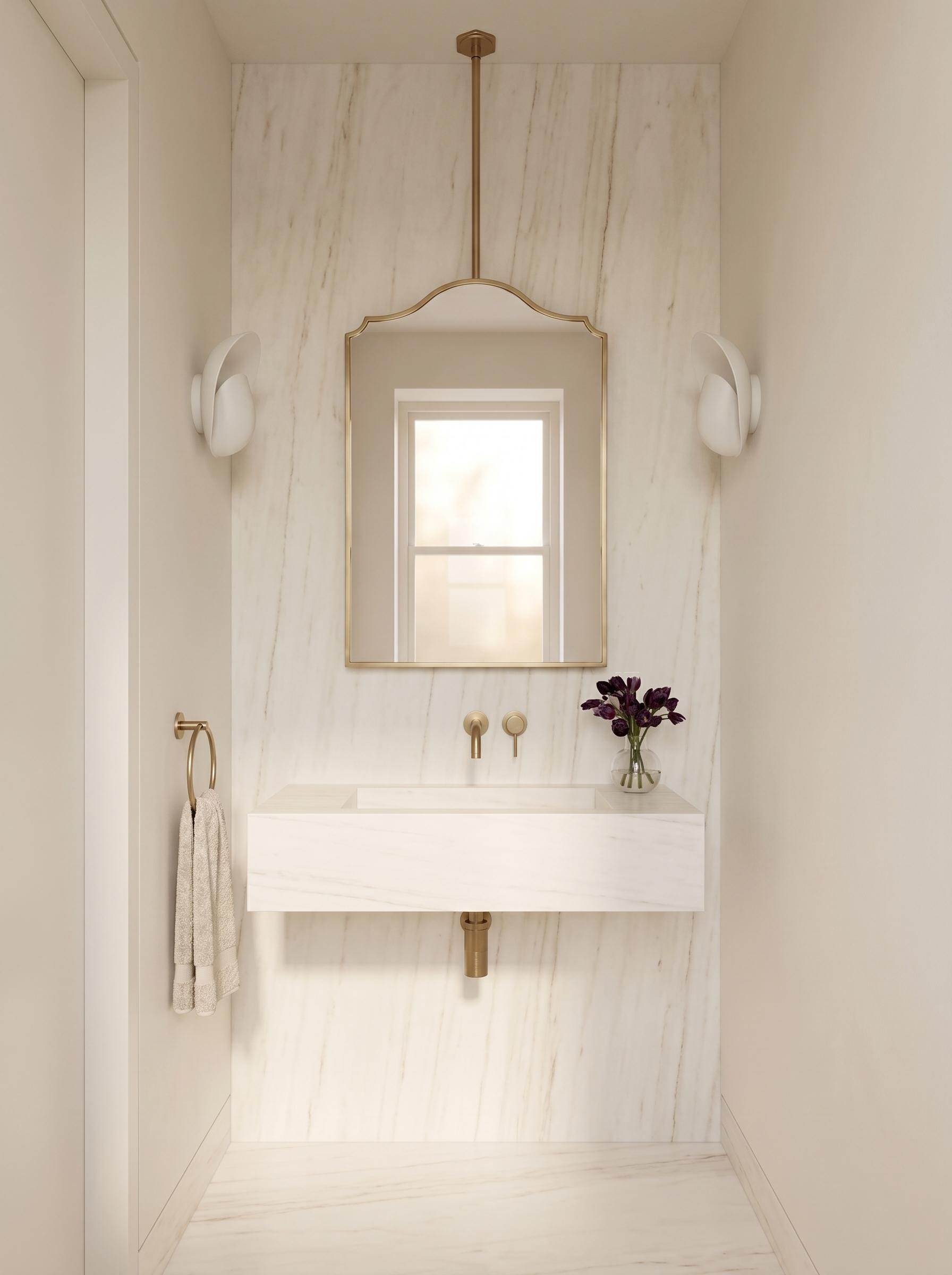 Modern brass vanity mirror above marble floating sink