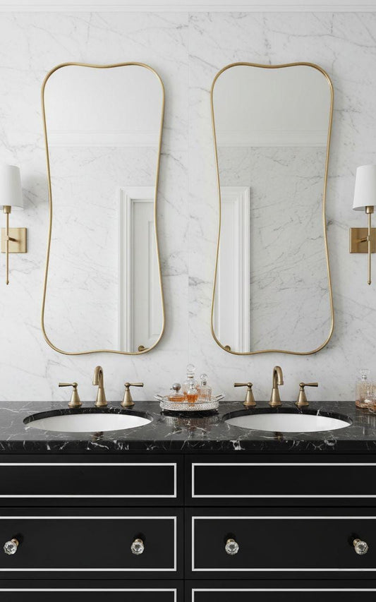 Pair of curved gold brass mirrors over double bathroom vanity