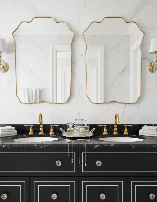 Double brass crest mirrors over marble bathroom sinks