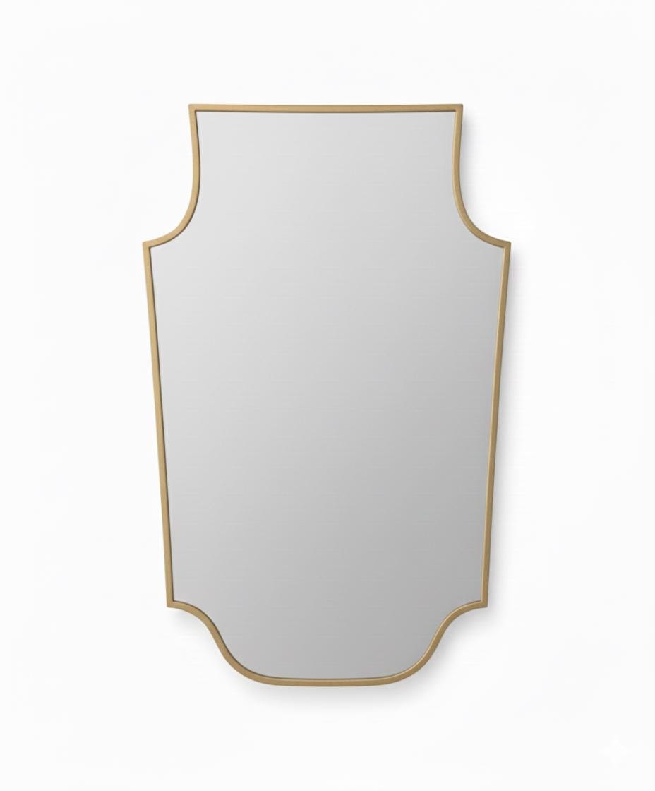 Shield-shaped brass mirror in a white background