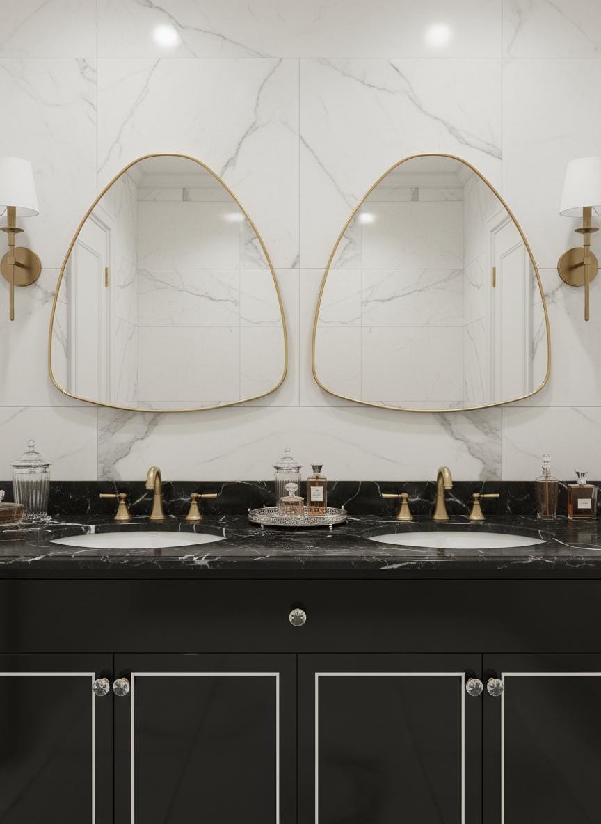 Double irregular brass bathroom mirrors over marble vanity