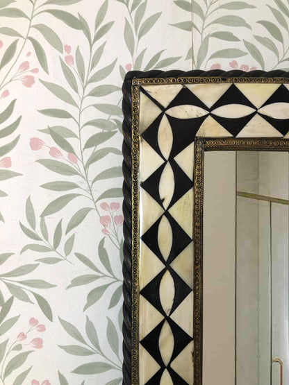Detail of top corner of the mirror frame