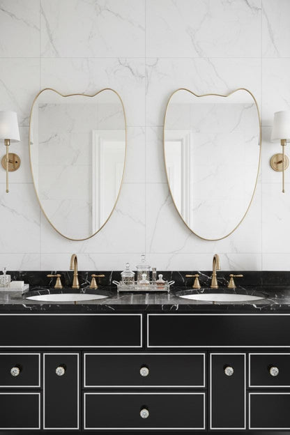 Pair of curved brass crest mirrors in luxury bathroom