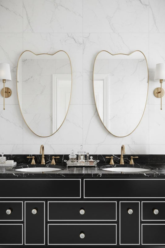 Pair of curved brass crest mirrors in luxury bathroom