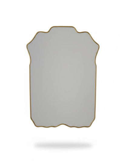Curved scalloped brass mirror  in a white background.