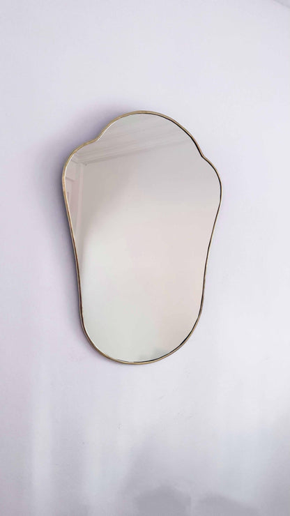 antiqued brass mirror on white wall