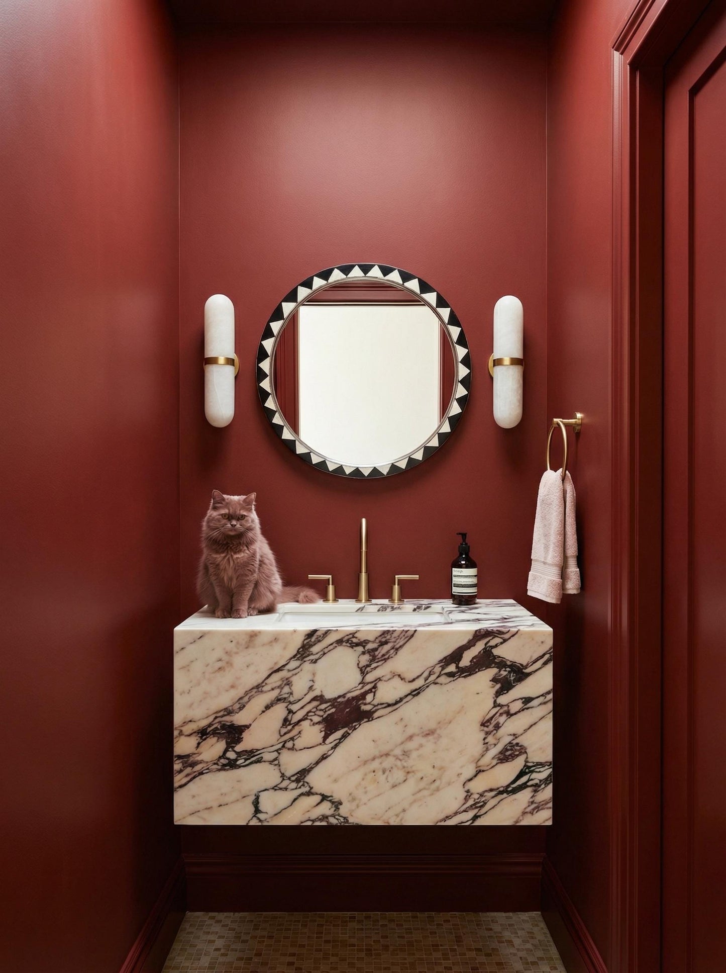 Black and white Moroccan round mirror in bold red bathroom interior