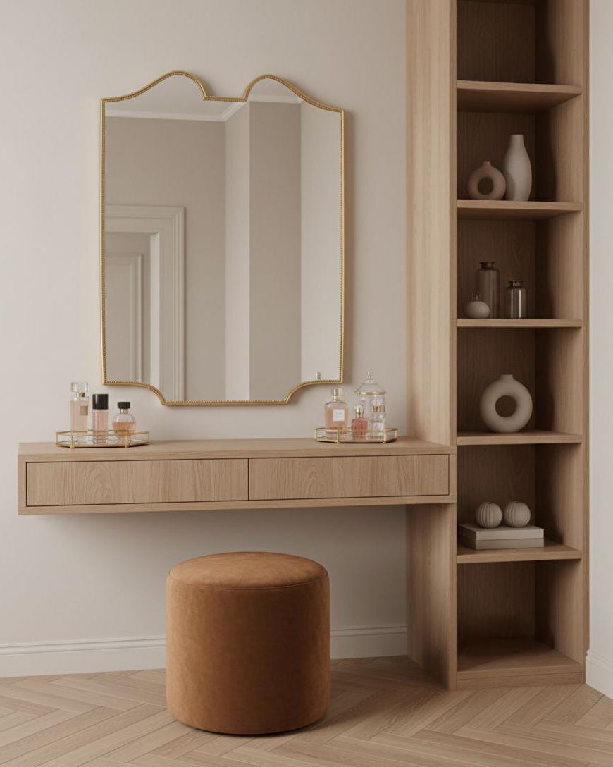 Scalloped brass wall mirror above wooden vanity with shelf styling