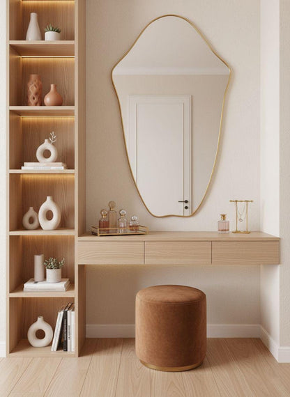Organic brass wall mirror above minimalist wooden console