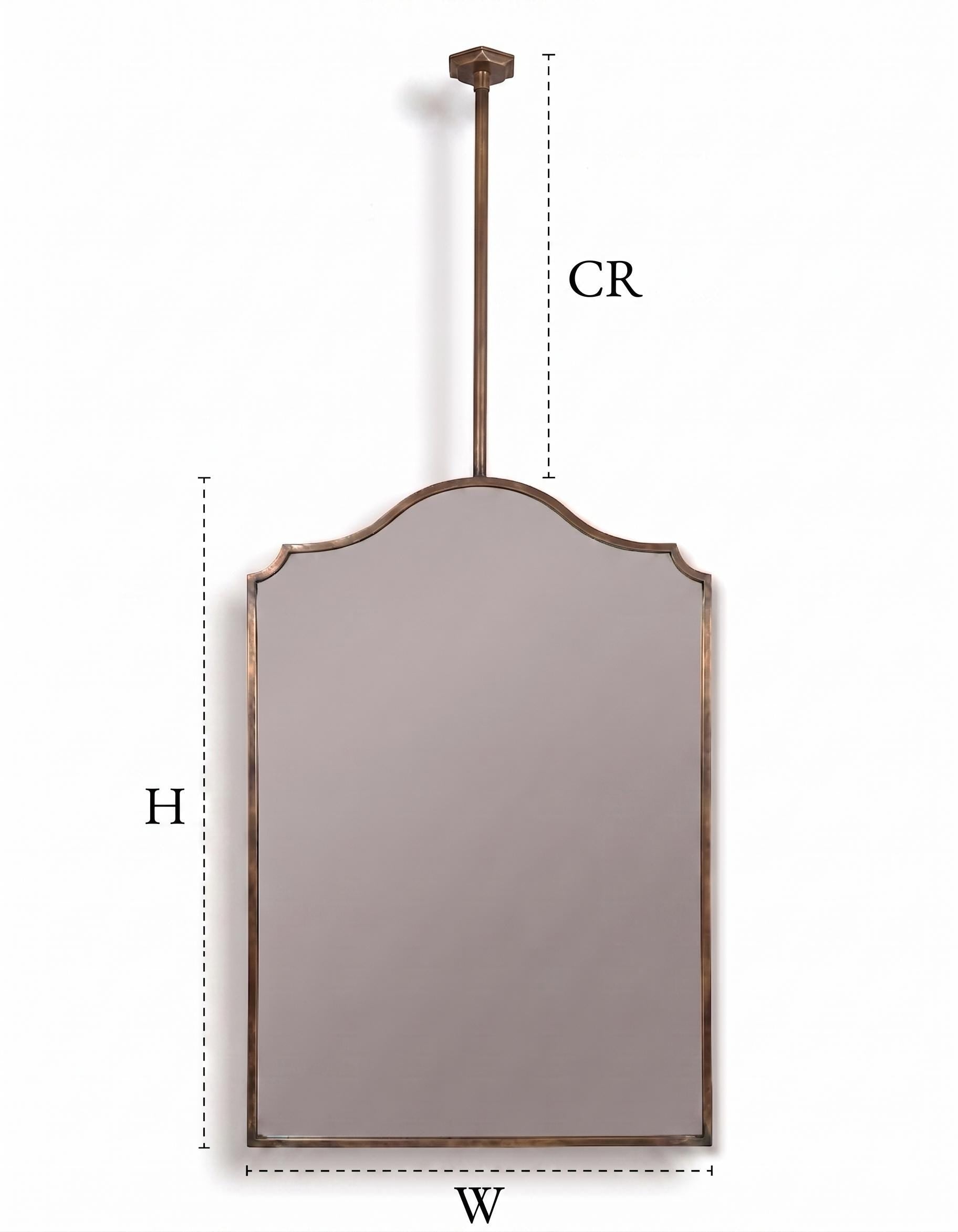 Scalloped brass hanging mirror with ceiling mounted rod