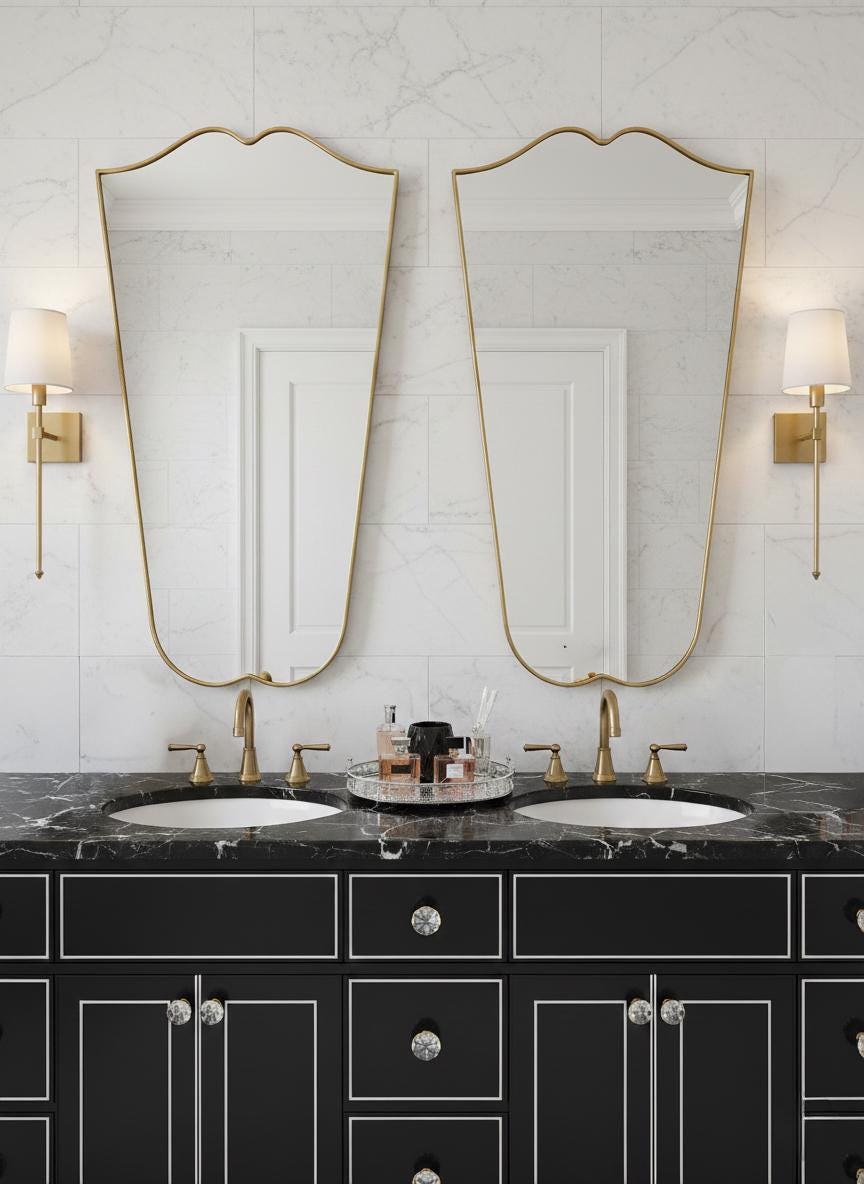 Pair of curved gold mirrors over double vanity