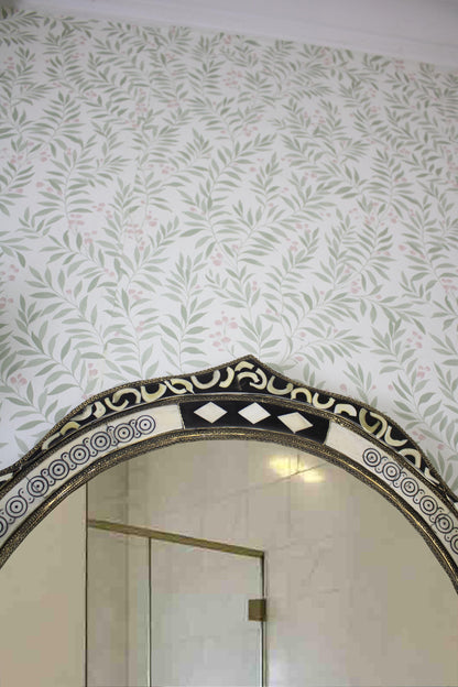 Upper section of the mirror with ornate trim and decorative wall molding.