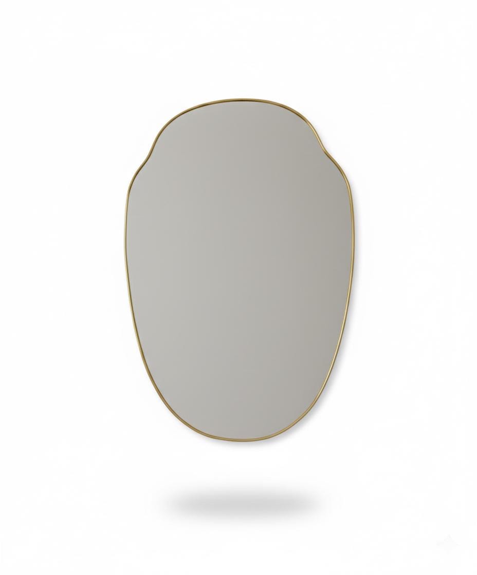 Irregular oval brass mirror in a white background