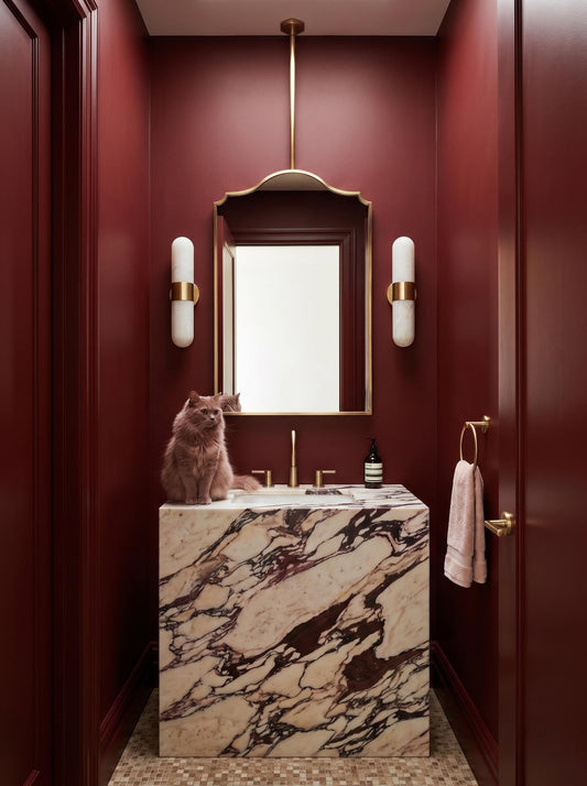 Elegant scalloped top brass mirror with warm wall sconces