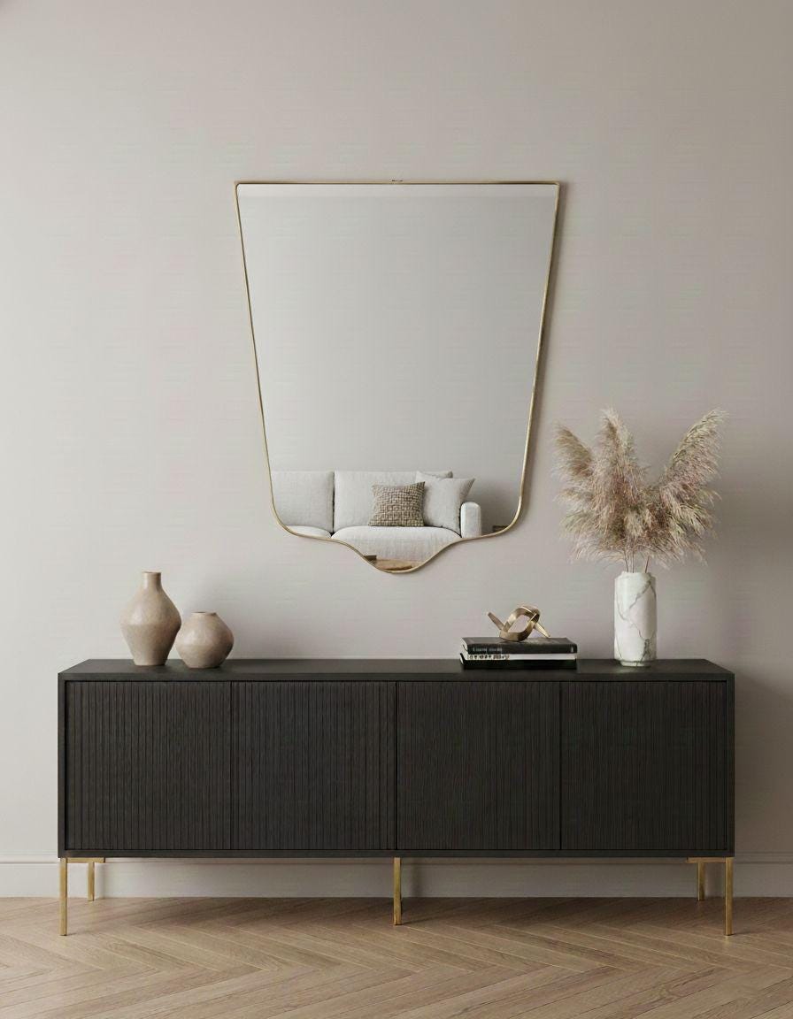 Handmade shield mirror over black sideboard