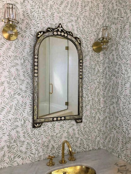 Elegant arched mirror with handcrafted inlay above gold tap