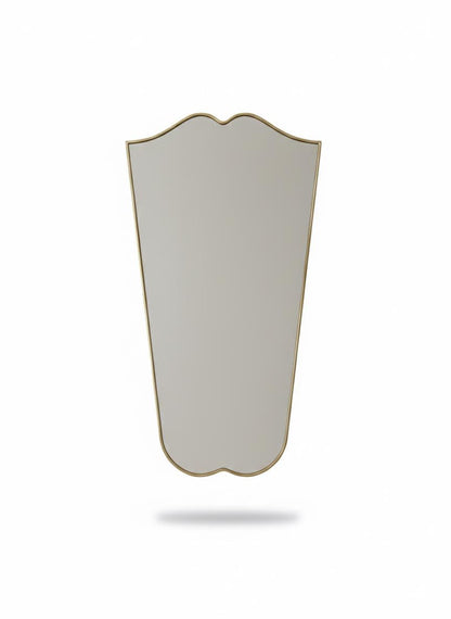 Tall curved gold mirror in a white background