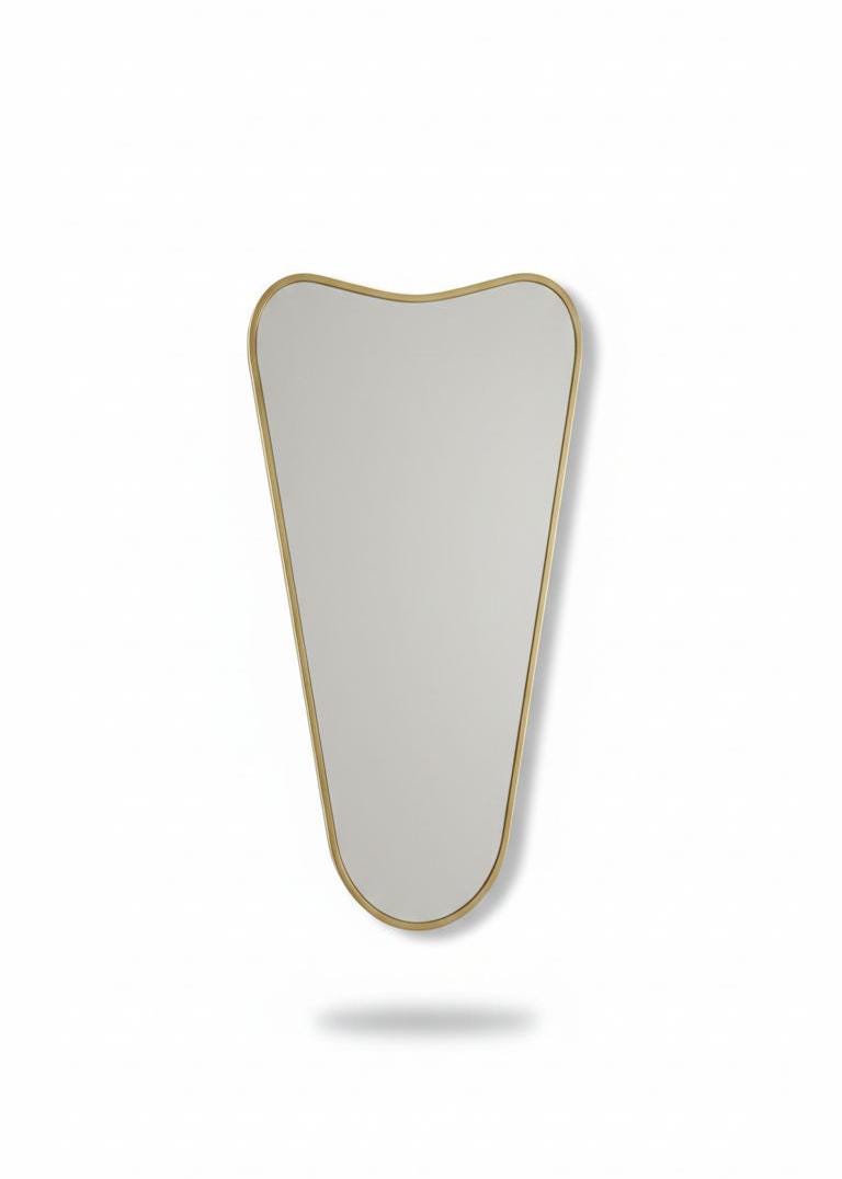 Curved top brass wall mirror in a white background