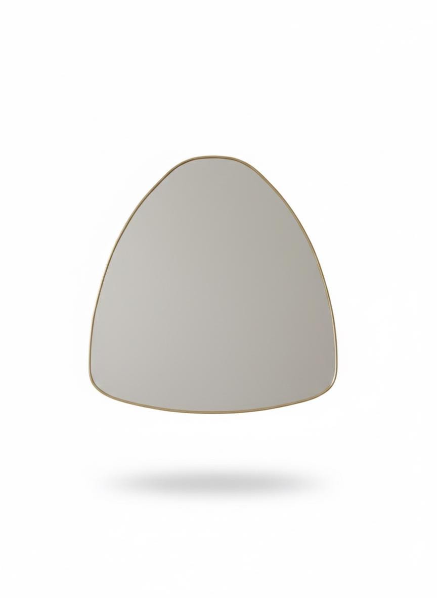 Irregular curved brass mirror in a white background