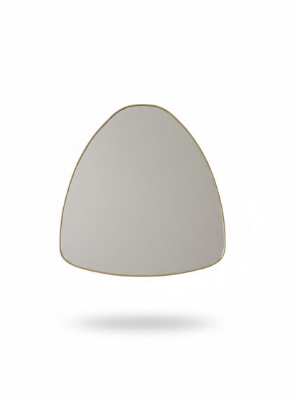 Irregular curved brass mirror in a white background