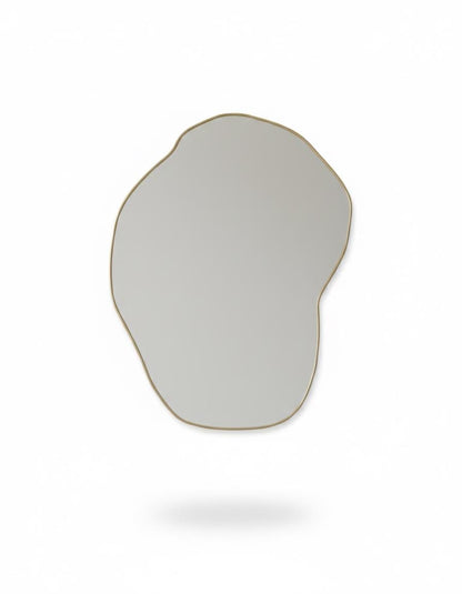 Irregular handmade brass mirror in white background