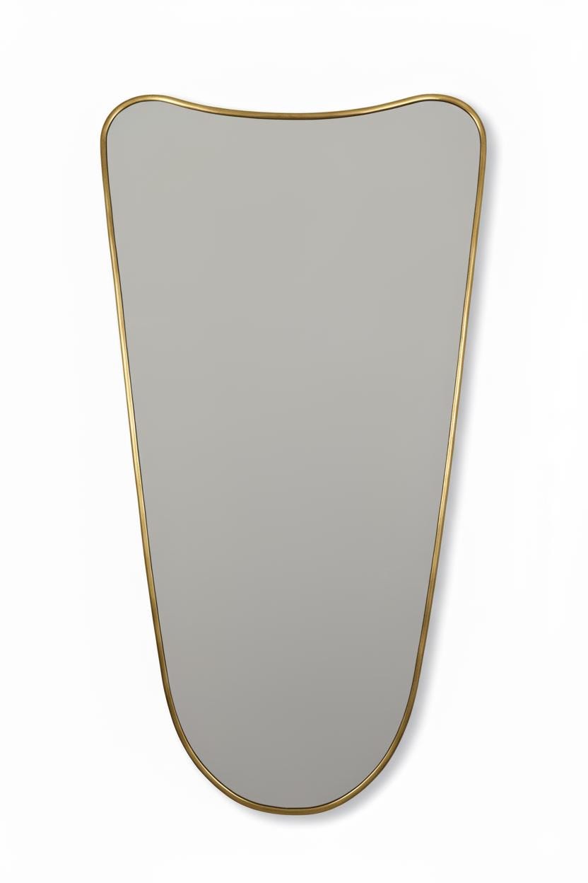 Close-up of curved brass mirror with smooth edges on a white background.