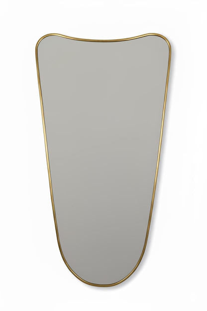 Close-up of curved brass mirror with smooth edges on a white background.