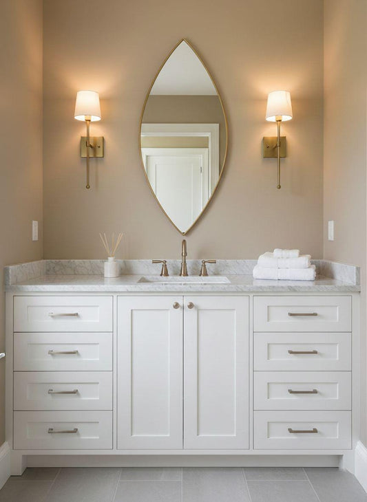 Pointed oval brass bathroom vanity mirror with wall sconces