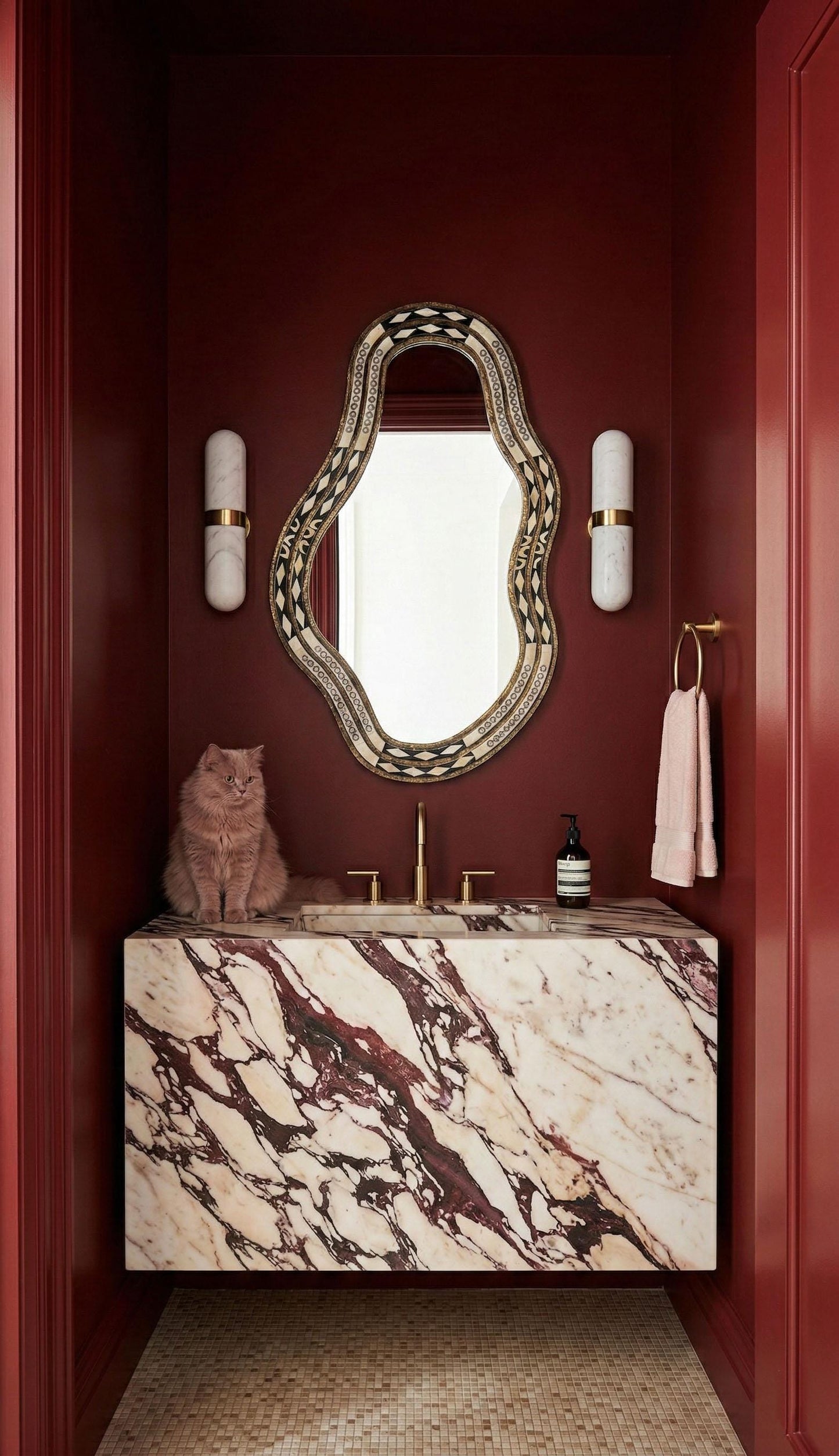 Handmade bone mirror in red powder room with marble sink