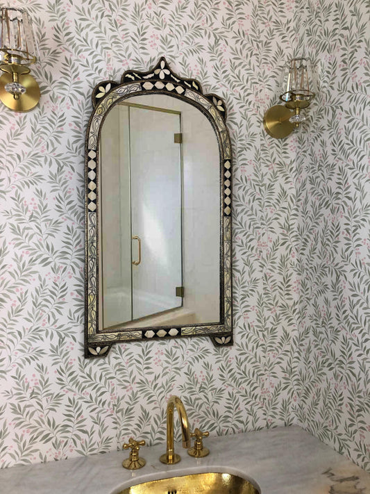 Arched bone inlay mirror with floral pattern over vanity sink