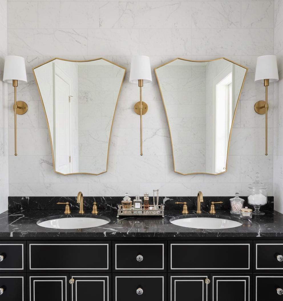 Pair of shield brass mirrors over double bathroom vanity